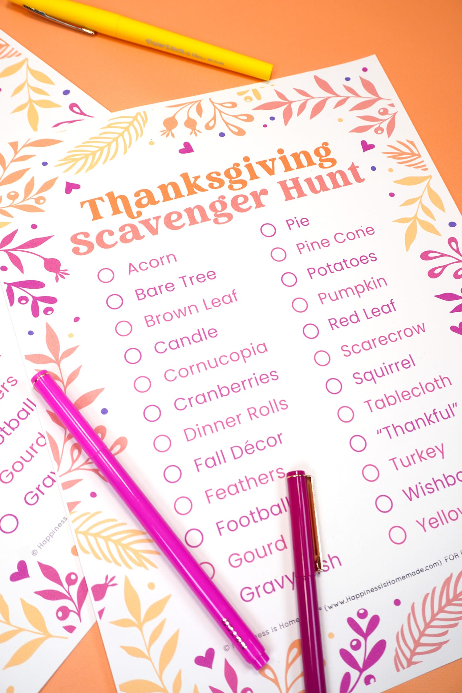 Close up of Thanksgiving Scavenger hunt free printable game and word list on an orange background