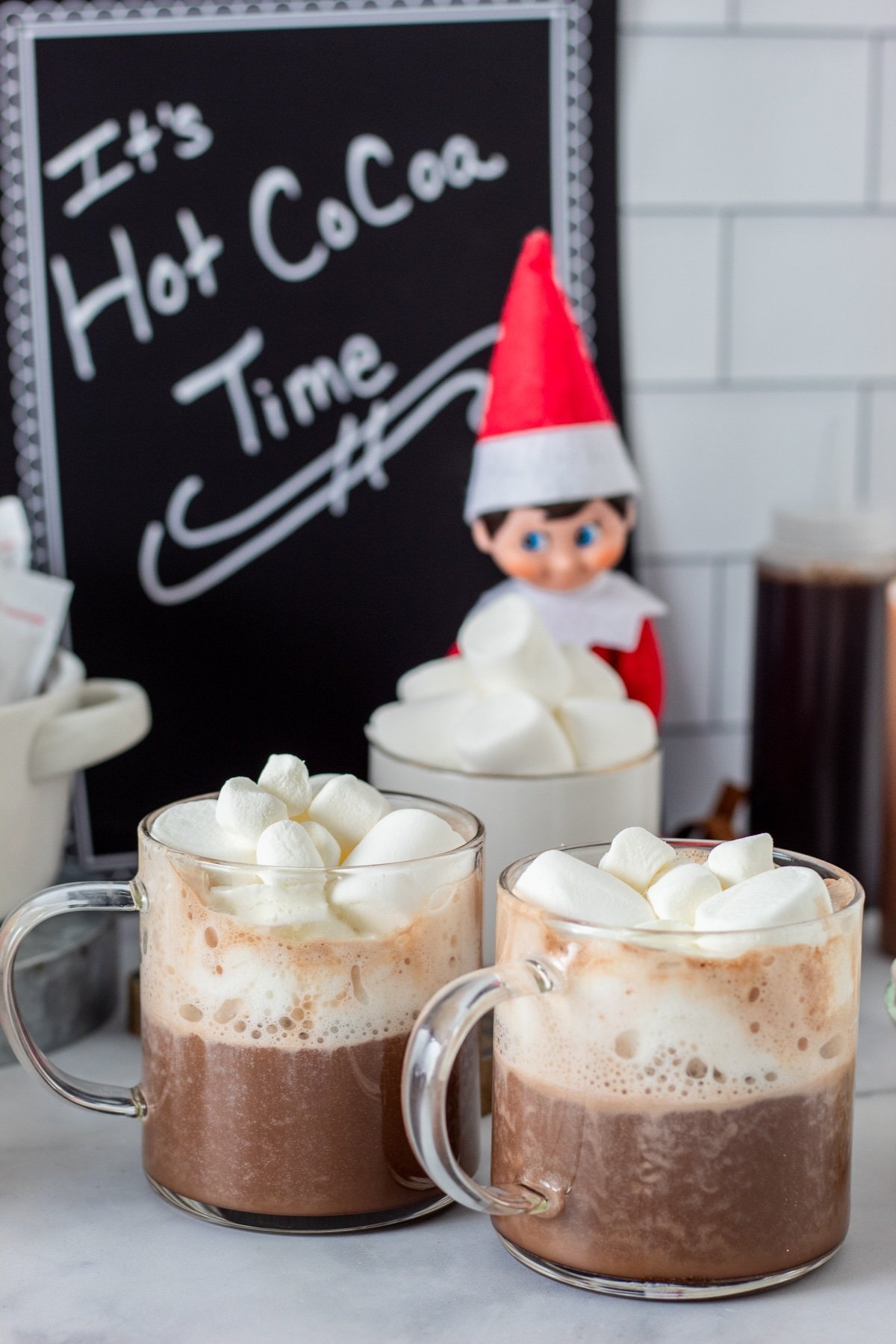 two glass mugs of hot chocolate with marshmallows 