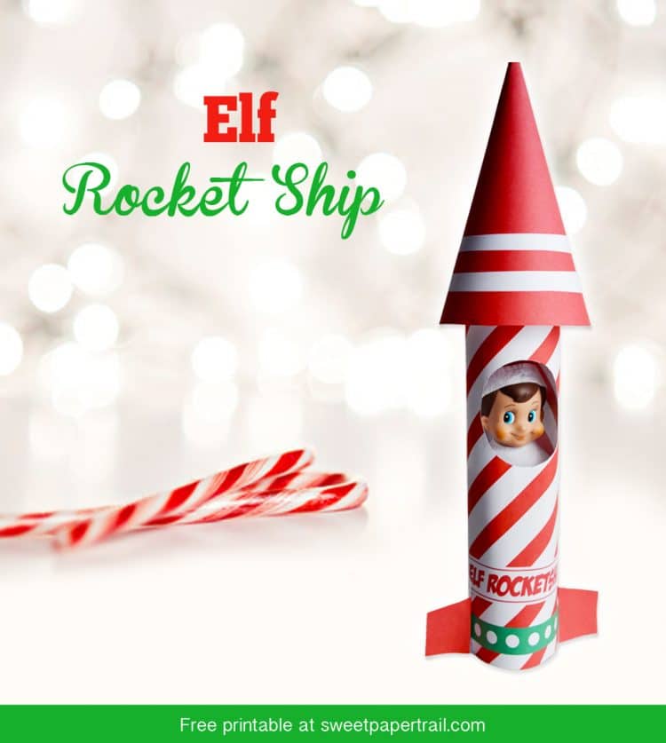 Red and white paper rocket ship with elf on the shelf doll inside