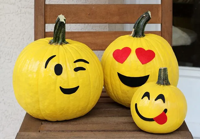 pumpkins painted like emojis 