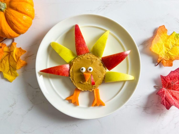 turkey food art on plate with fall leaves and decor