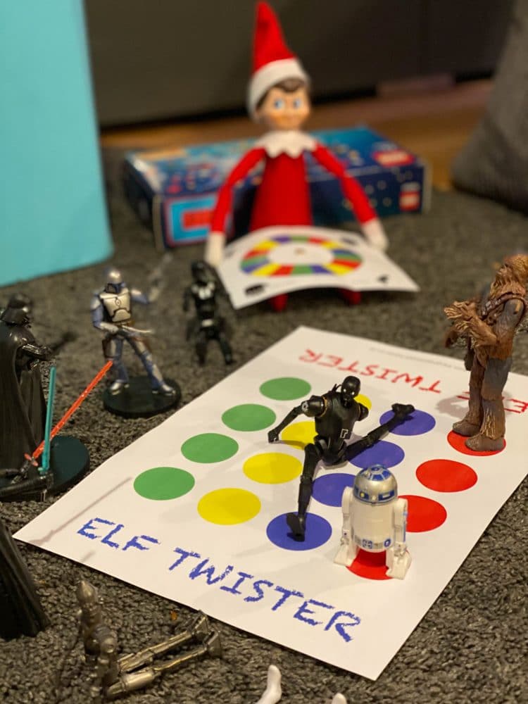 Elf on the shelf size printable twister game on grey background with star wars characters around it
