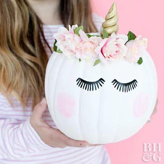 girl holding cute unicorn pumpkin