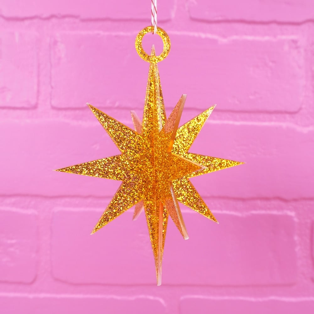 3d star ornaments cut out from MDF wood painted with glitter