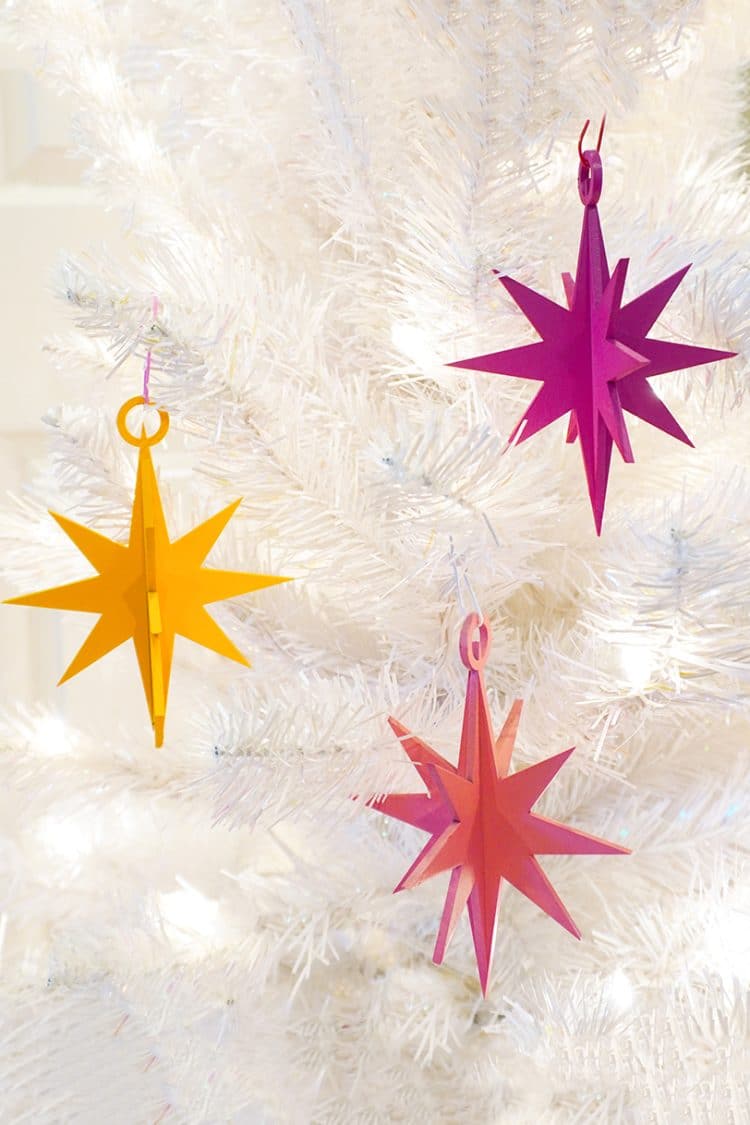 3d star ornaments hanging on white tree