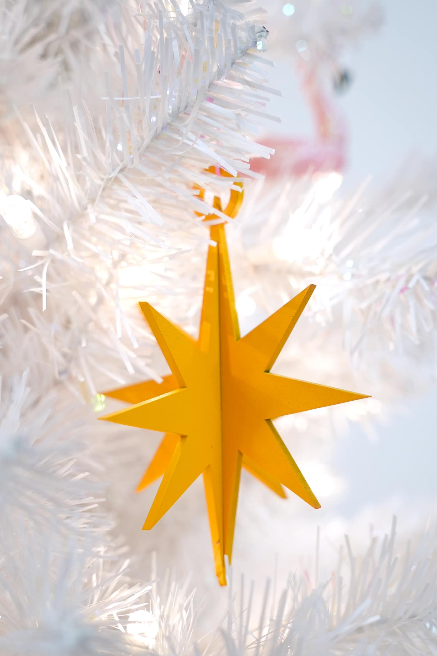 3d star ornaments cut out from MDF wood hung on tree