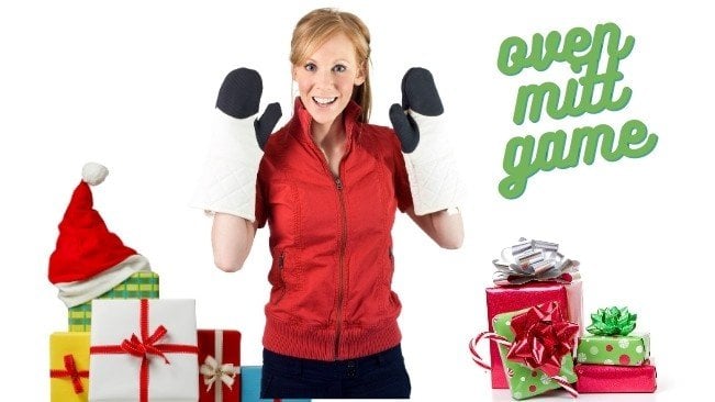 lady wearing over mitts with christmas presents