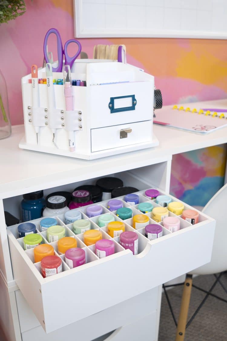 studio paint storage drawer open revealing organized paints