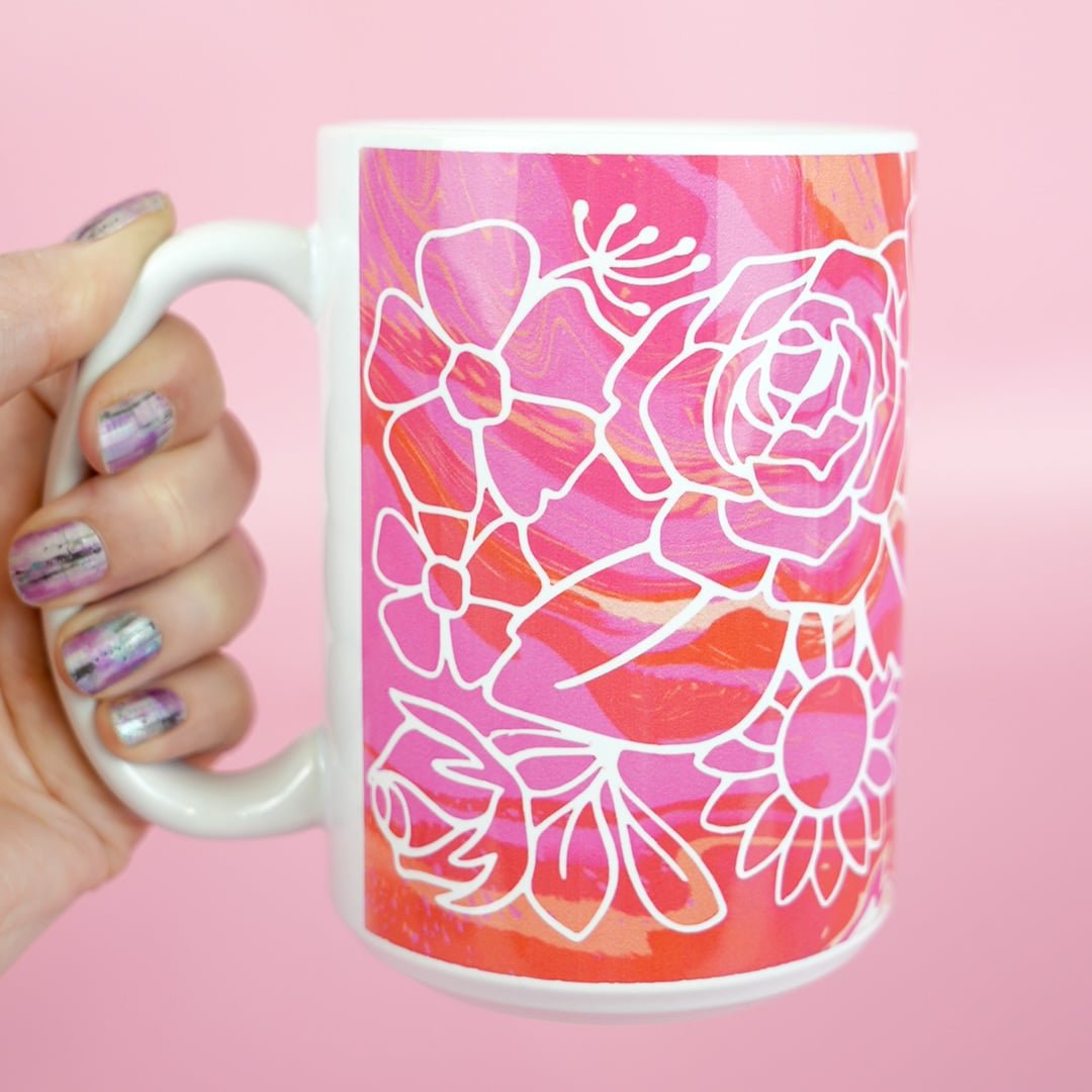 hand holding finished floral infusible ink mug