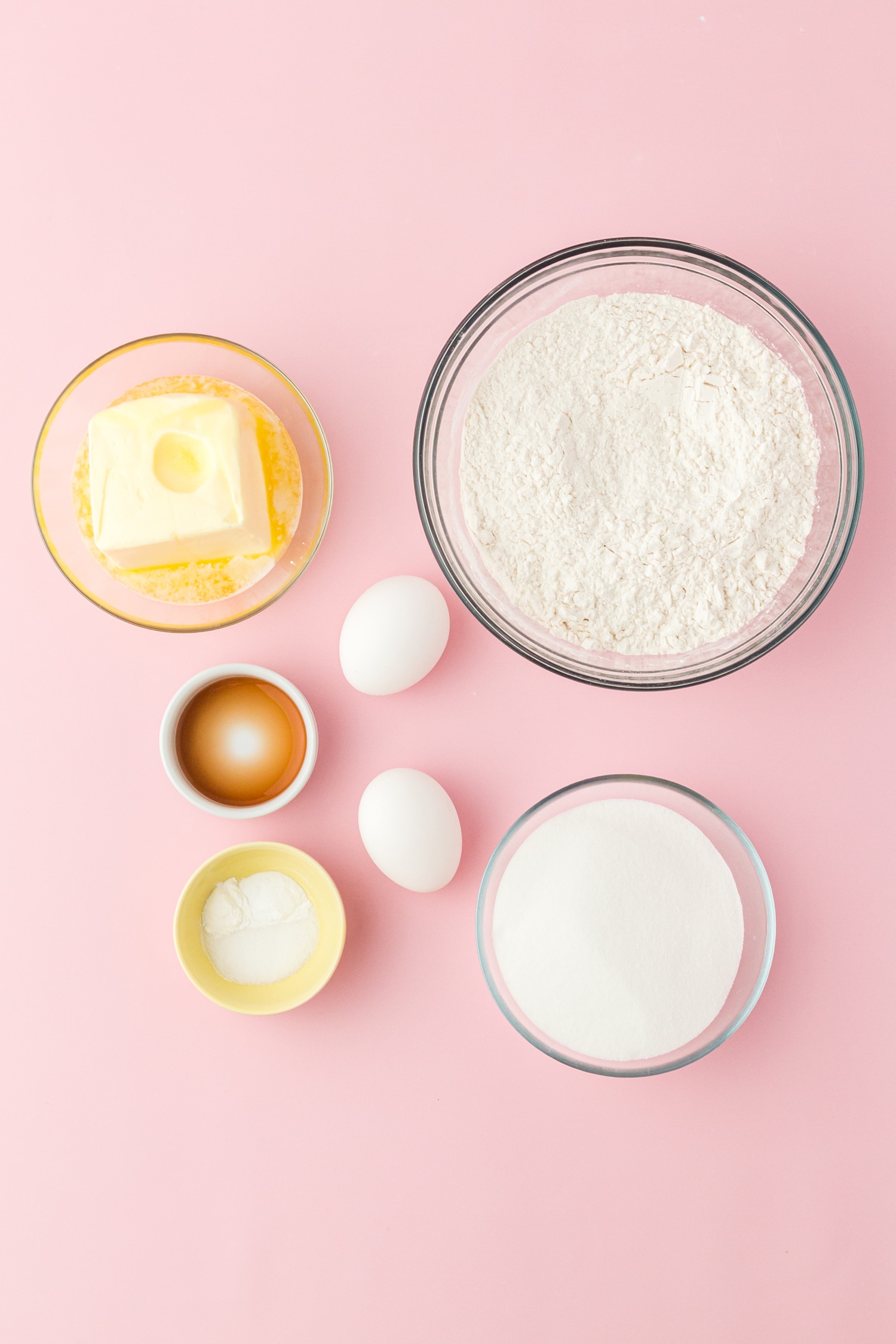 Ingredients for sugar cookies on pink background