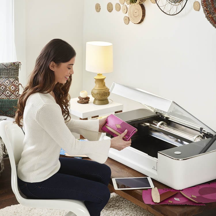 lady pulling project from glowforge machine