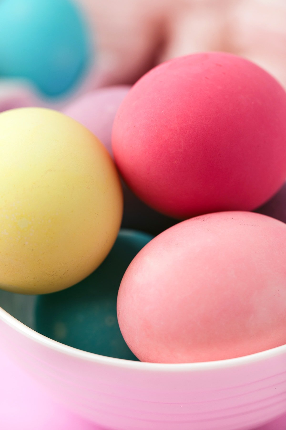 Close up of colorful pink and yellow Easter eggs in bowl