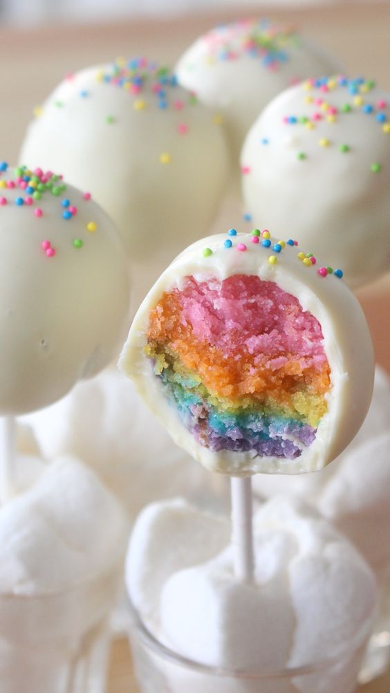 rainbow filling half eaten cake pop with sprinkles