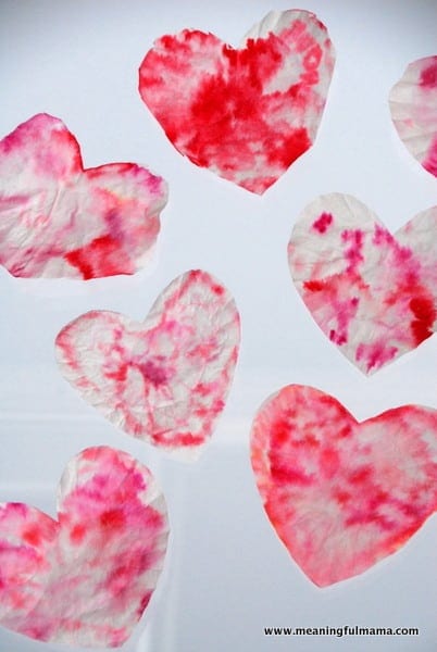 Red and pink dyed coffee filters in shape of heart.
