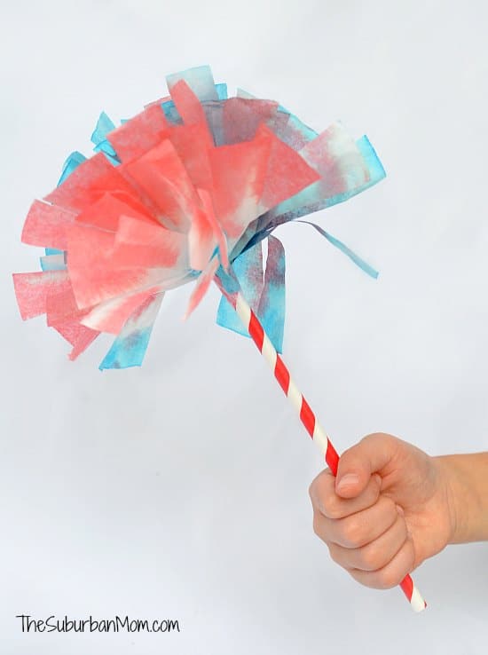 Blue and red dyed coffee filters on a red and white straw