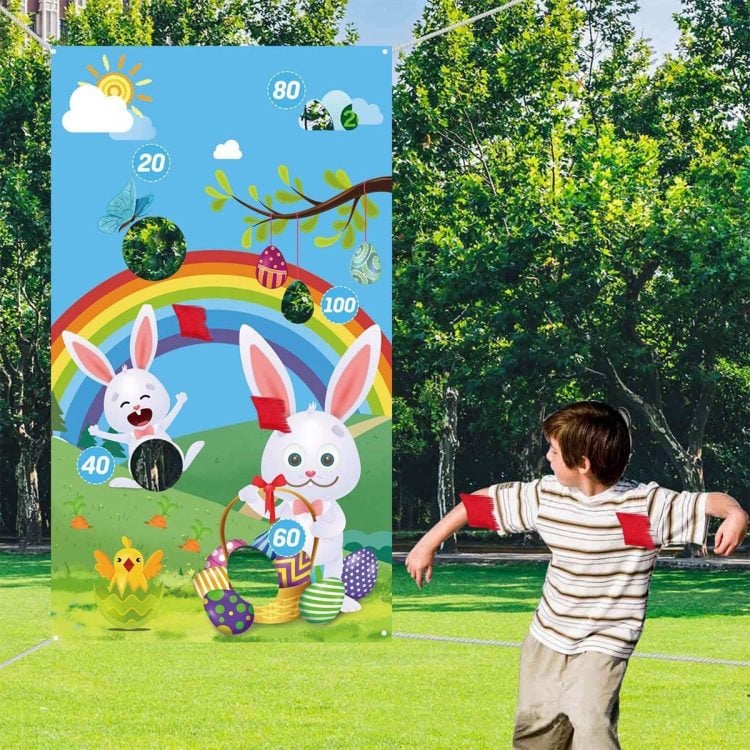 bean bag toss with easter themed bean bag score board and young boy playing game