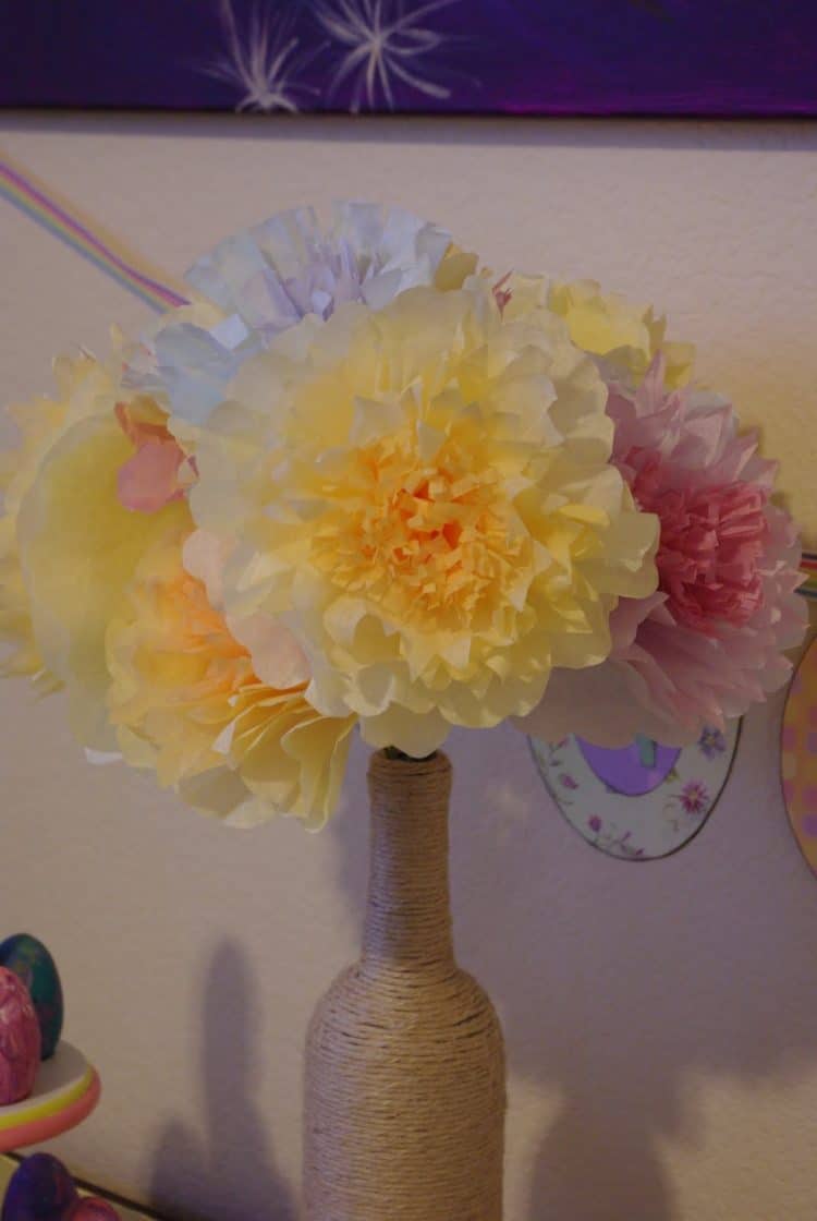 Yellow and pink coffee filter flowers in a twine wrapped bottle.