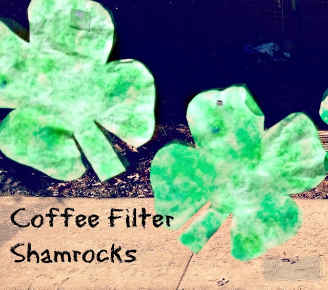Green and white coffee filters in shape of a four leaf clover.