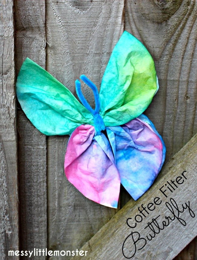 Multi-colored coffee filters wrapped with a pipe cleaner to look like a butterfly
