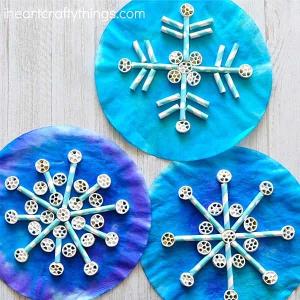 Blue coffee filters with paper straws and pinwheel pasta to look like a snowflake.