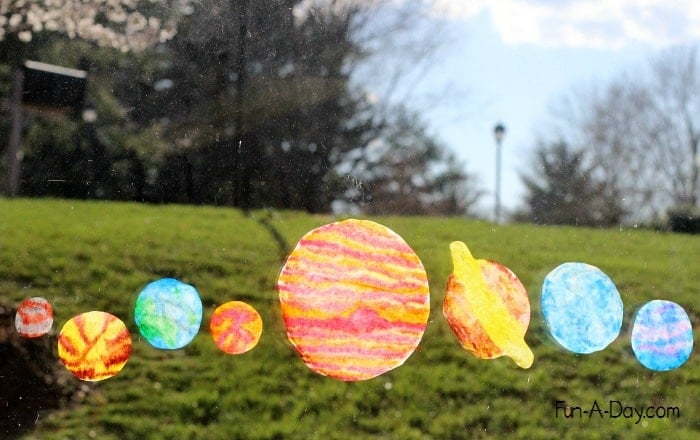 Colored coffee filters shaped to look like the planets in the solar system.