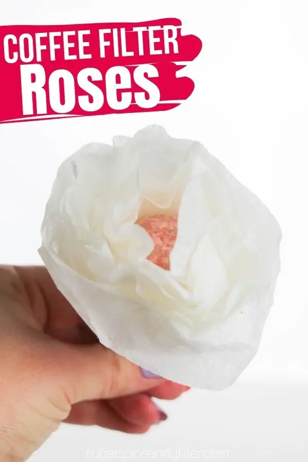 White coffee filter shaped into a rose with a candy ball center.
