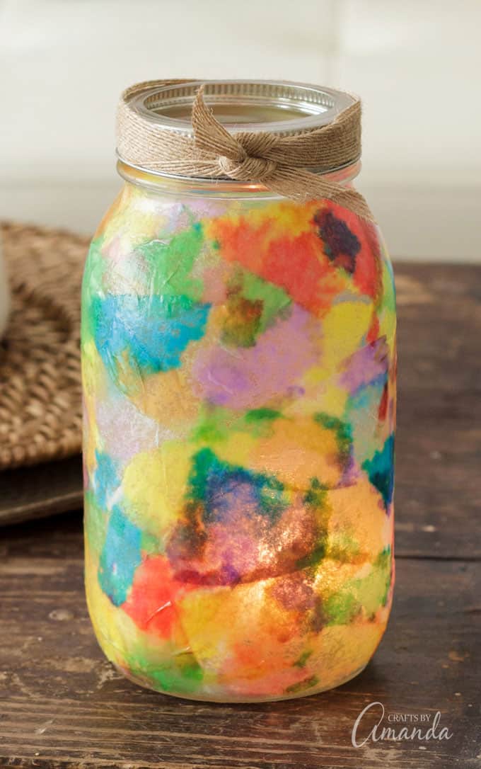 Multi-colored coffee filter pieces glued to mason jar.