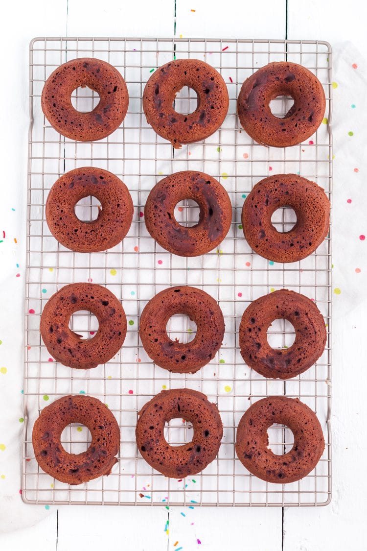 Baked chocolate donuts on a wire cooling rack