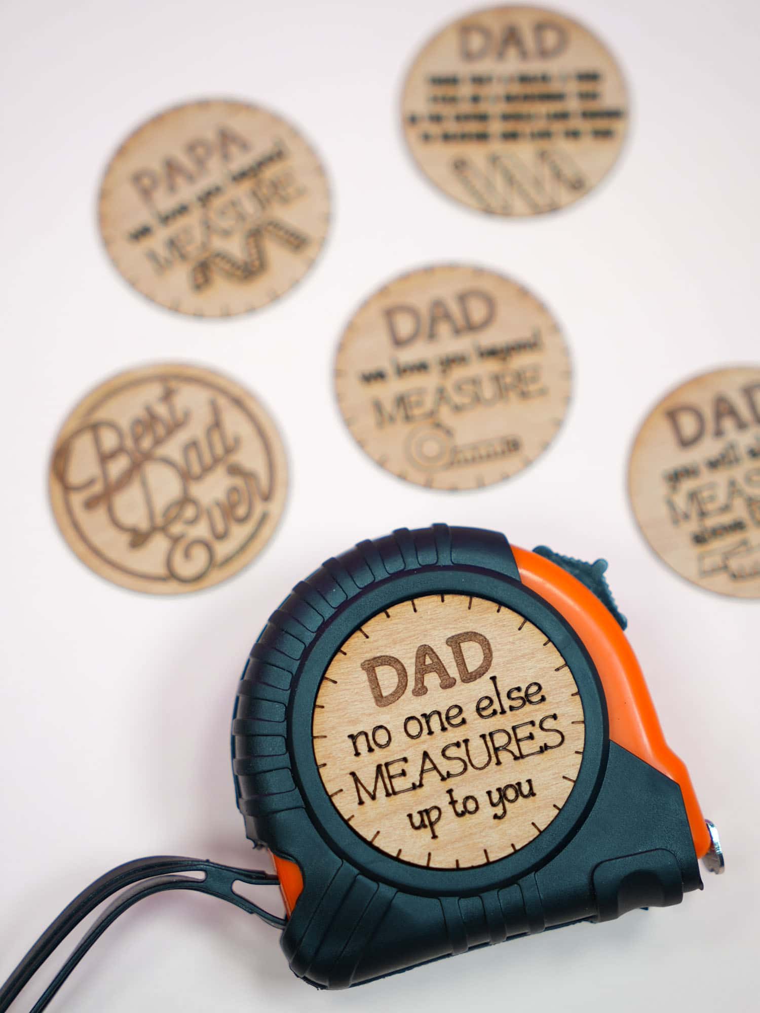 "Dad No One Else Measures Up to You" wood sticker on black and orange tape measure