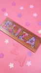 "Eliza" name puzzle on pink background with clear E-L-I-Z-A acrylic puzzle pieces