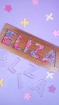 "Eliza" name puzzle on lavender background with clear E-L-I-Z-A acrylic puzzle pieces