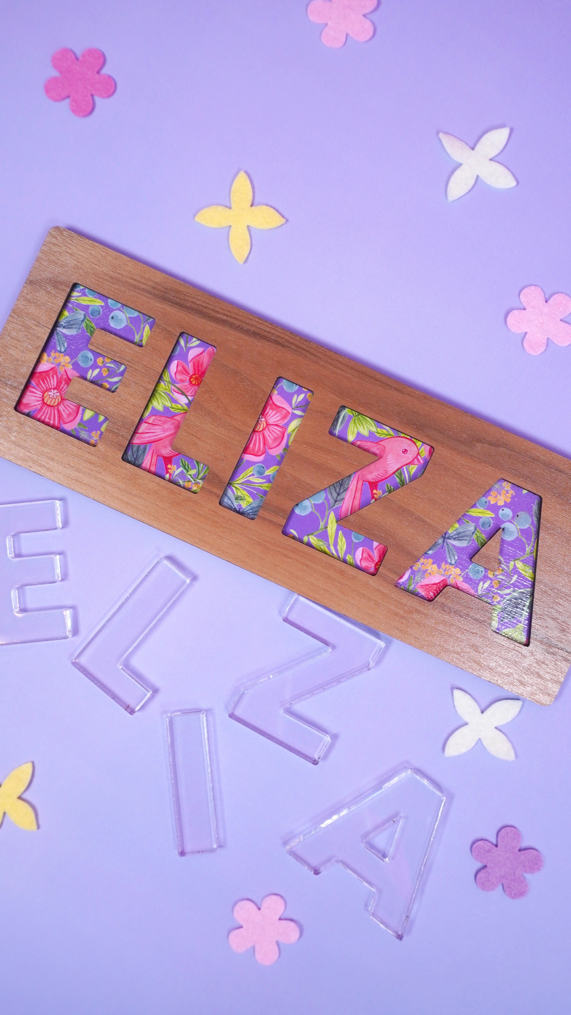 "Eliza" name puzzle on lavender background with clear E-L-I-Z-A acrylic puzzle pieces