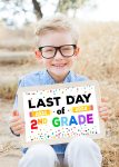 boy holding last day of school sign