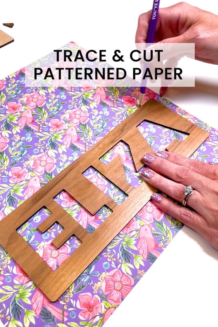 hands tracing patterned paper to make a custom name puzzle