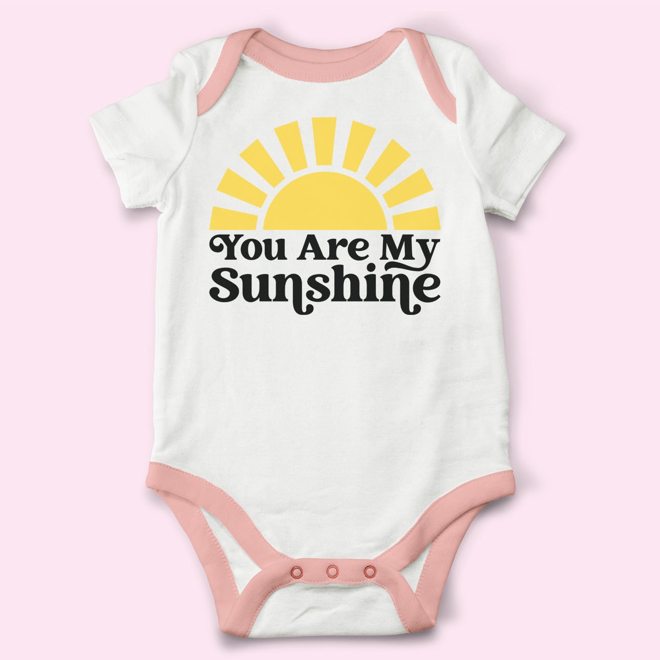 you are my sunshine svg file on baby onesie with pink background