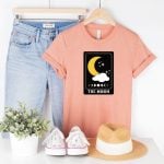 moon tarot card svg file on salmon colored shirt styled with jeans hat and shoes