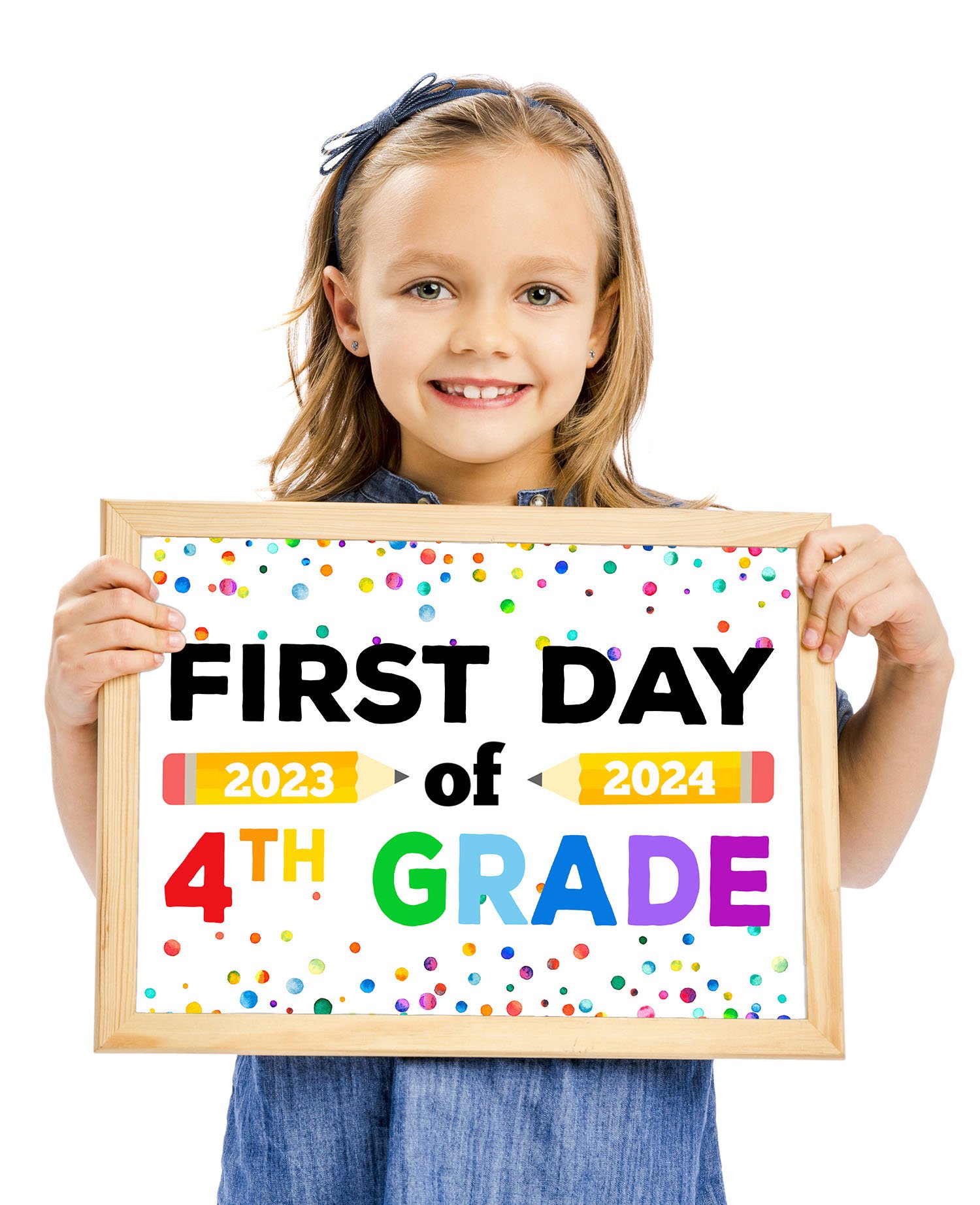 Cute white girl with short brown hair holding a First Day of 4th Grade sign