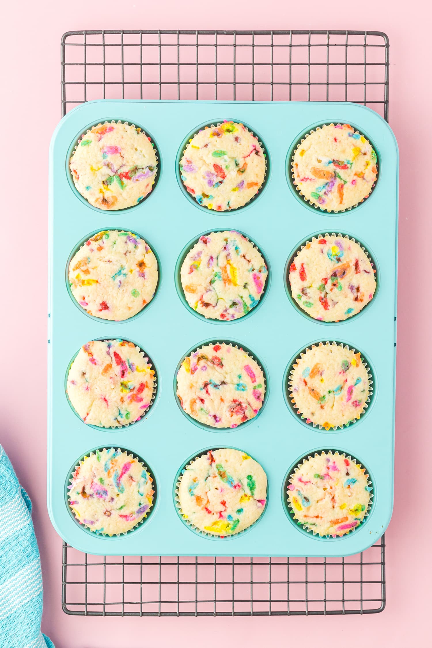 Colorful freshly baked Funfetti cupcakes cooling on a rack