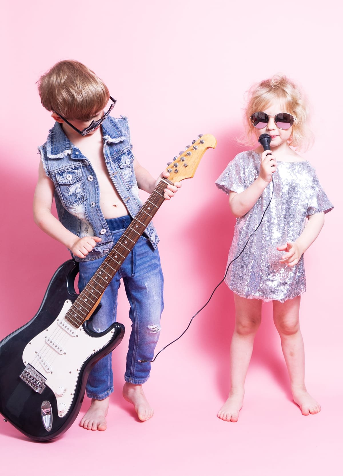 kids playing guitar and singing in microphone