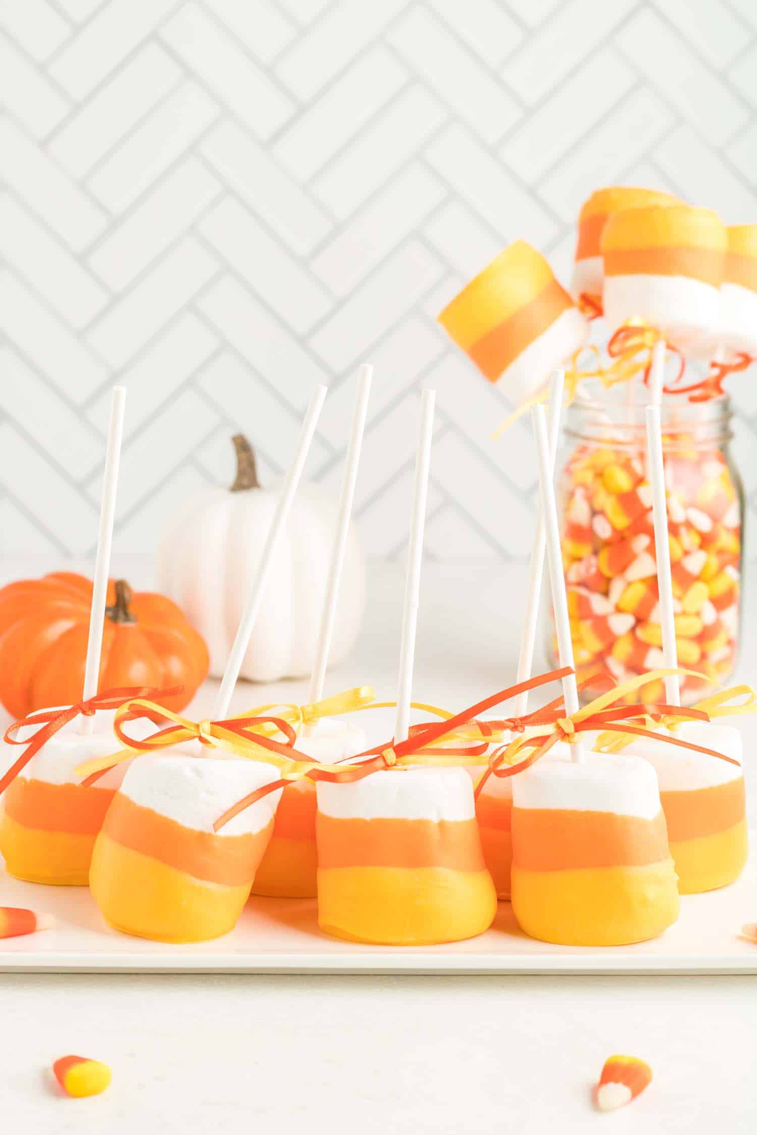candy corn marshmallow pops with candy corn jar background