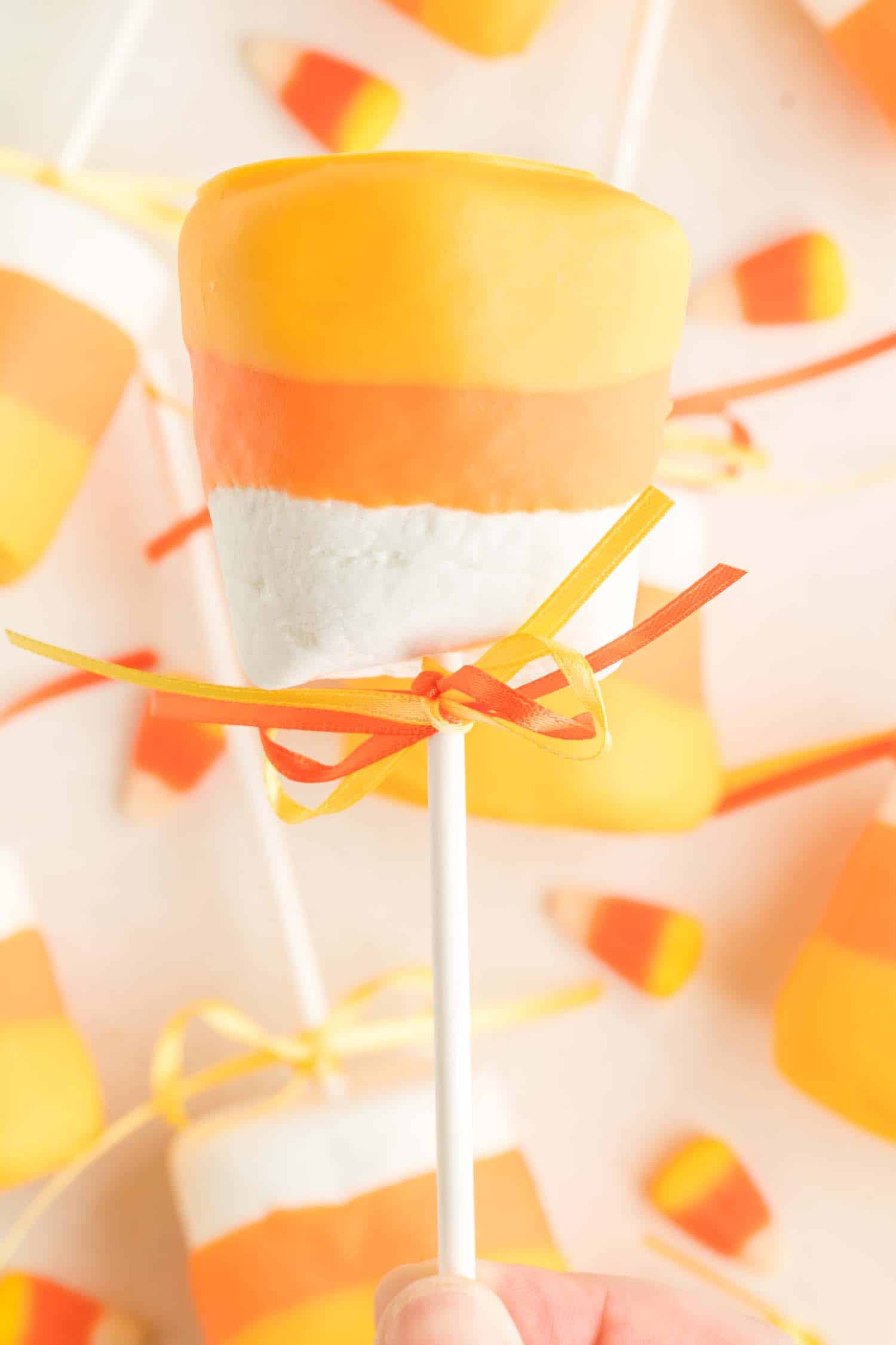 Orange and yellow candy melt dipped marshmallow pop. 