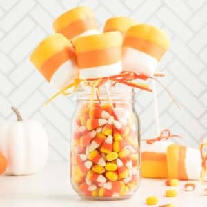 a candy jar filled with candy corn and candies