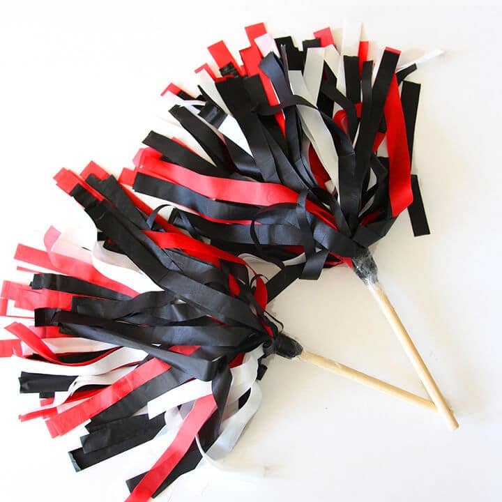 two cute black, red, and white pom poms for team spirit activity