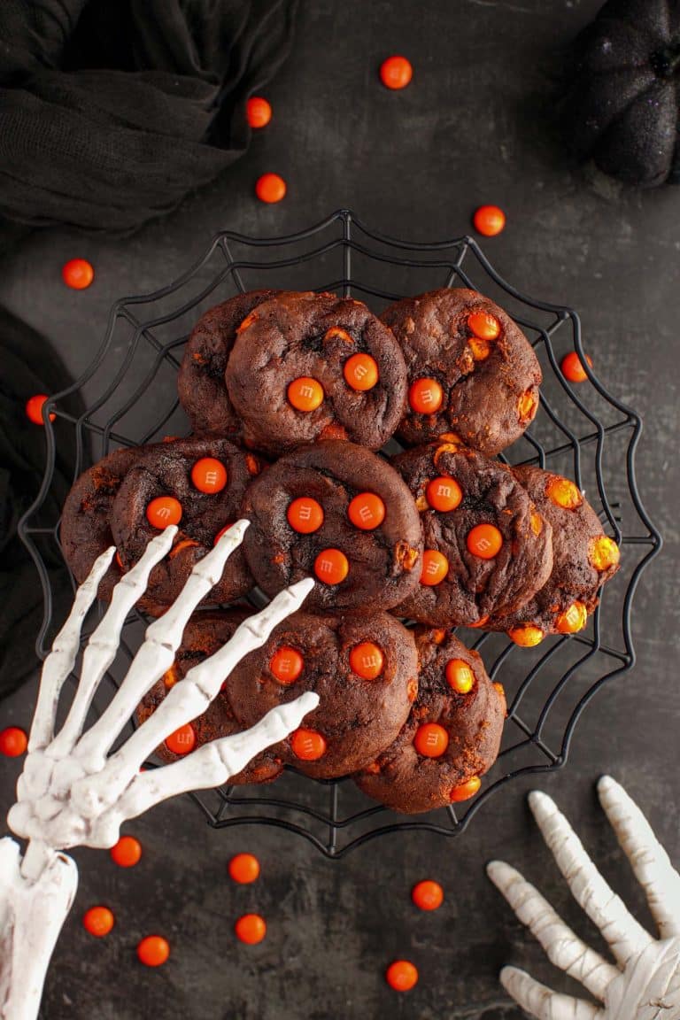 skeleton hand over plate of Halloween cake mix cookies