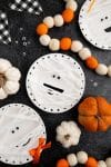 Paper plate mummy craft with funny faces and pumpkins