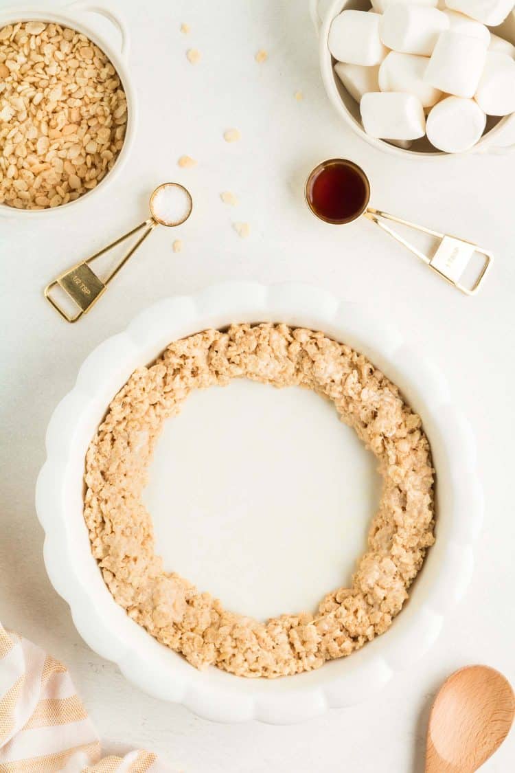 Layering Pumpkin Pie Rice Krispie Treat Ingredients in white Dish