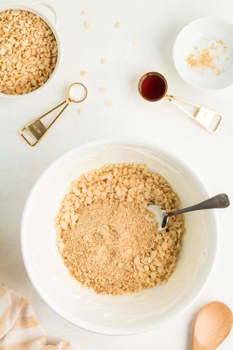 Mixing Pumpkin Pie Rice Krispie Treat Ingredients in Bowl on White Tabletop Background