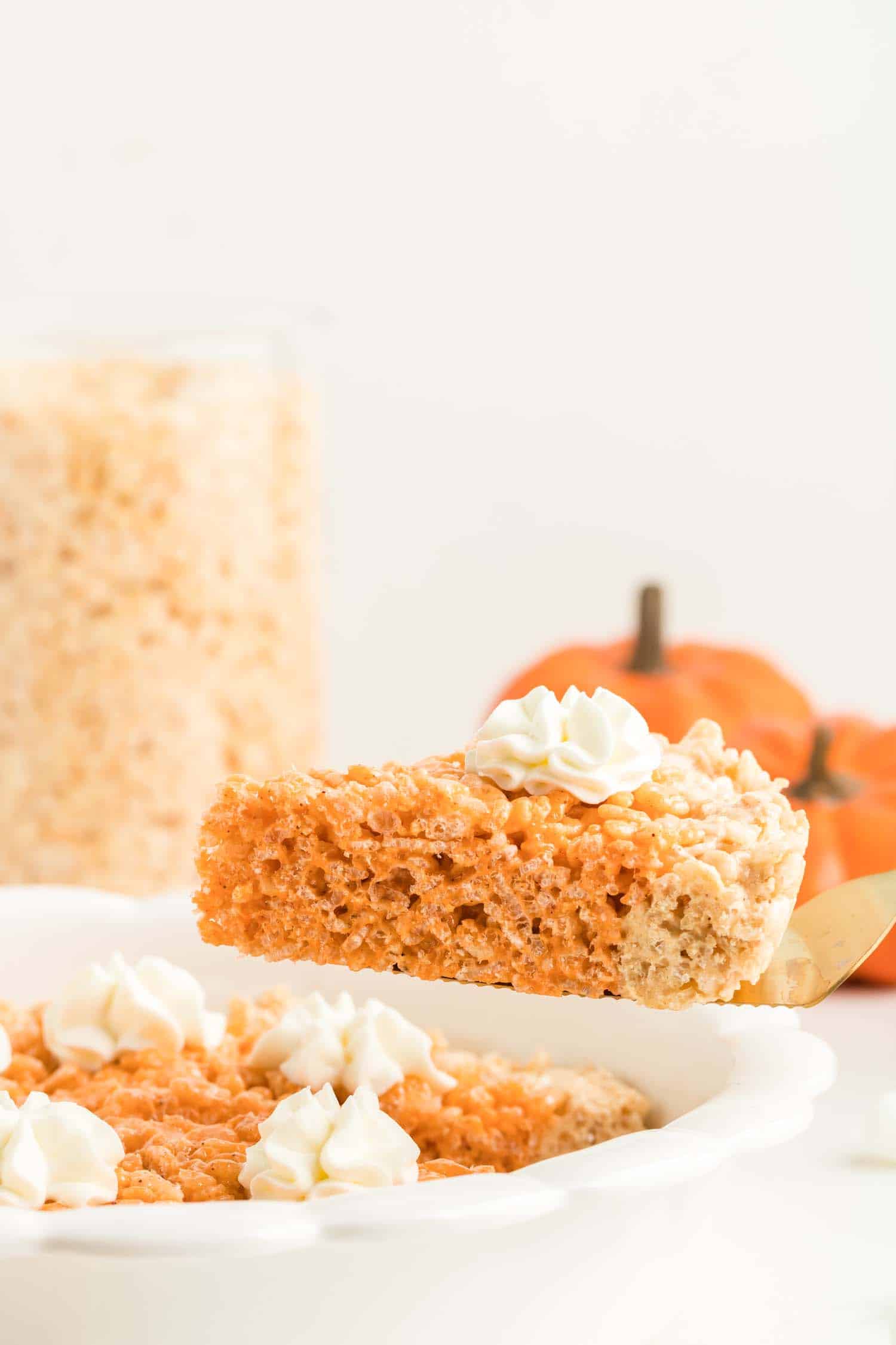 Side View of Pumpkin Pie Krispie Treat on Fork lifted from White Dish
