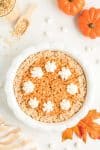 Pumpkin Pie Thanksgiving Treat Sliced in White Dish on Fall Tabletop Background