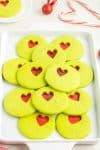 Green Sugar Cookies on White Plate Candy Cane Background